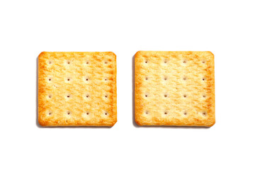 Salty cracker cookies on a white background. A couple of biscuit on the table. Morning breakfast snack. Wheat light meal snack in lunch time.