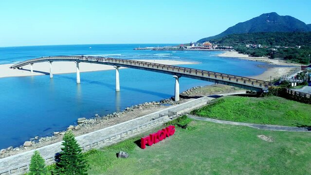 Aerial shot of Fulong Water Bridge with tropical landscape and mountains in background - Taiwan,Asia
