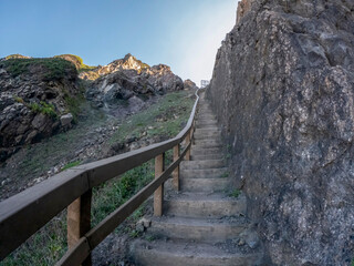 Fototapeta na wymiar A staircase to the dinosaur footprints on the cliffs of Praia Grande, Portugal