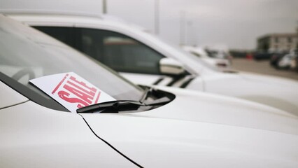 Close up of sale banner from new car. Concept of purchase and selling car. Auto business concept. Car dealerships, used cars,luxury cars,auto dial.
