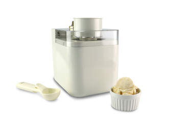 nice design ice cream maker machine is isolated on the white table with scoop spoon and a cup of home made vanilla ice cream with white cement wall background in gelato ice cream shop (clipping path)