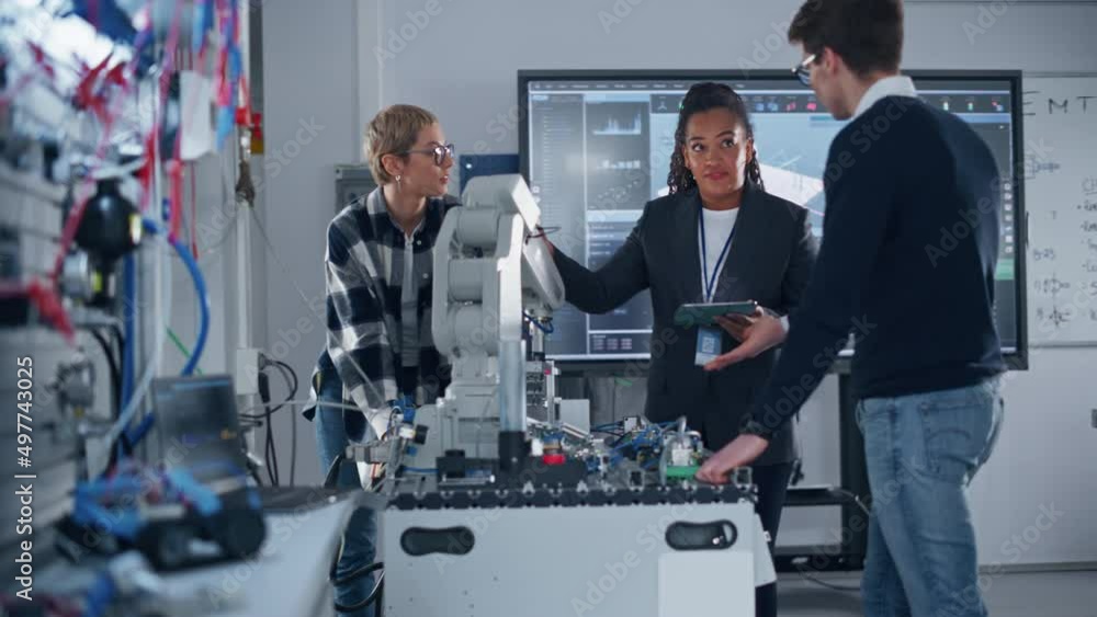 Aufkleber In Robotics Development Laboratory: Female Teacher and Two Students Work With Robotics Prototype Hand. Student Girl Telling Something with Smile and Brainstorming with her Team