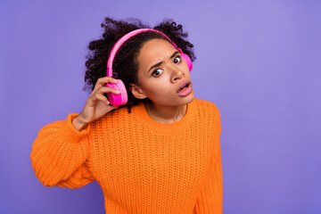 Portrait of attractive worried girl listening song hit overhear eavesdrop isolated over bright...