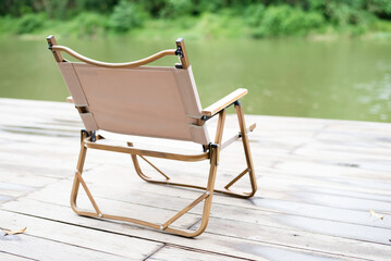 Single chair put on wooden timber board,riverside