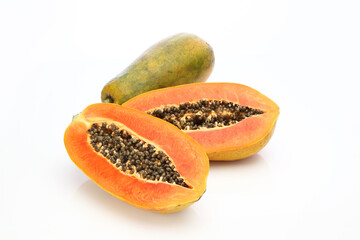 whole and half of ripe papaya fruit with seeds isolated on white background