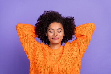 Portrait of attractive dreamy girl wearing cozy pullover resting isolated over bright purple violet...