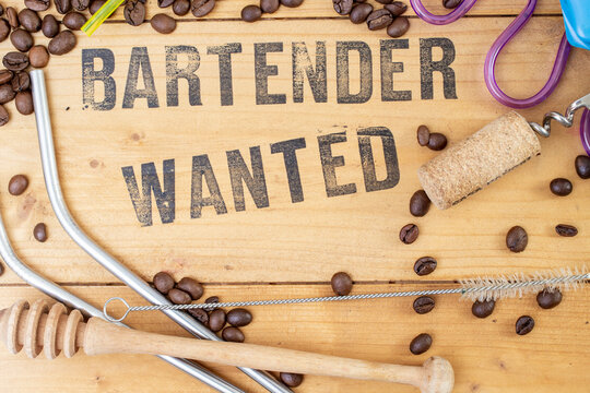 Bartender wanted, written on wooden boards surrounded by coffee beans and bar utensils. Recruitment rustic sign.  - Powered by Adobe