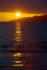 Freighter at Sunset English Bay. Sunset over English Bay and a freighter at anchor. Vancouver, British Columbia.

