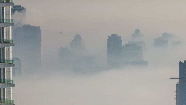 Dubai Aerial view showing fog over al barsha heights and greens district area timelapse