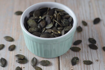 Peeled pumpkin seeds in a small bowl	