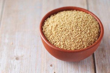 Dry couscous in a small ceramic bowl	