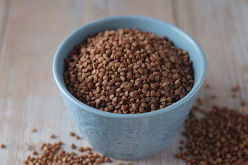 Buckwheat grain in a small ceramic bowl	