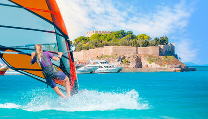 Windsurfer surfing the wind on waves in Kusadasi - Pigeon Island with a 