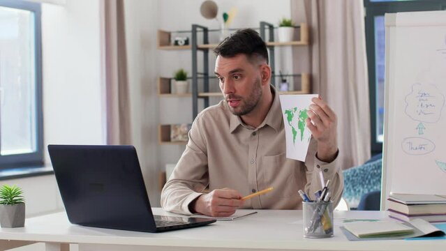 distance education, school and remote job concept - male geography teacher with world map and laptop computer having online geography class at home office