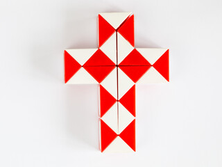 red and white bicolor magic snake Transformable twist puzzle in shape of cross isolated on white background. it develops spatial thinking