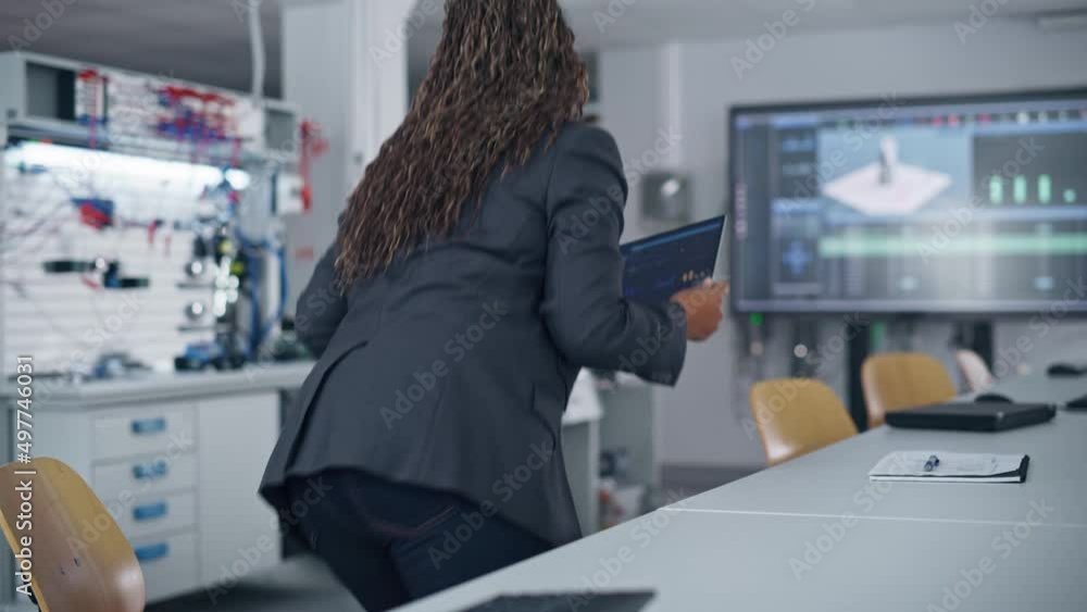 Poster At the Factory: Automation Black Engineer Uses Laptop for Programming Robotic Arm while Sitting at Table and then Going to Robot. New Era in Automatic Manufacturing Industry Concept