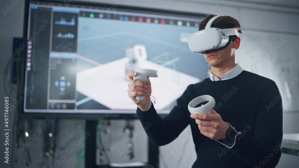 Poster Futuristic University: Caucasian Male Engineer Wearing Virtual Reality Headset Uses Controllers to Remotely Moving Robotic Hand in Special App. Action of Robot Displayed on Screen