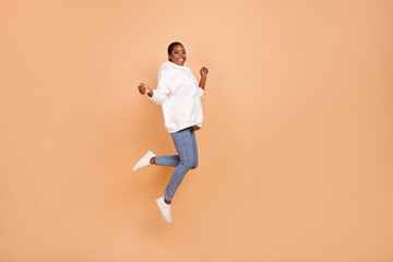 Fototapeta na wymiar Full size photo of overjoyed energetic person have fun good mood jumping isolated on beige color background