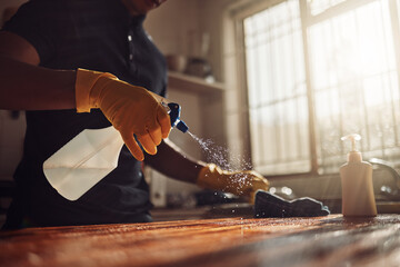 I dont need a magic wand, Ive got my hands. Shot of an unrecognisable man disinfecting a kitchen...