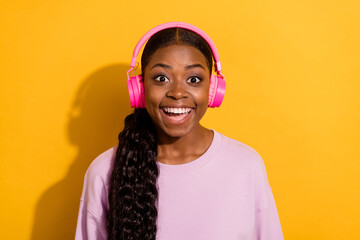 Photo of crazy astonished girl enjoy playlist melody look camera isolated on yellow color background