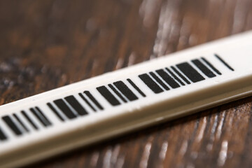 Tiny plastic security anti-theft barcode sticker with chip.