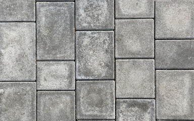 Rough textured surface of large gray paving slabs, close up. Pavement tile pattern, top view