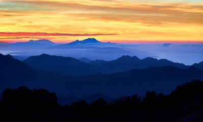 Sunrise over the mountains
 at Kelimutu volcano. Ende Regency, East Nusa Tenggara, Flores, Indonesia, Asia. Travel photo.