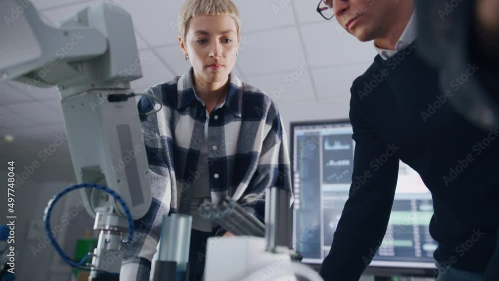 Poster Students Gathering Around Bionic Robot Arm with Female Teacher and Studying Engineering at University Robotics Class. Computer Science Education Build, Design, Learn Concept. Low Angle View