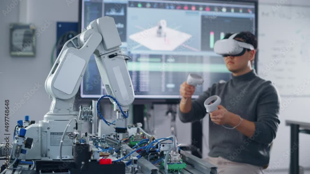 Poster student wearing virtual reality headset holding controllers and moving bionic claw under his control