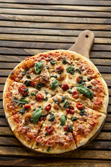 mixed organic vegetables vegetarian pizza on wood board