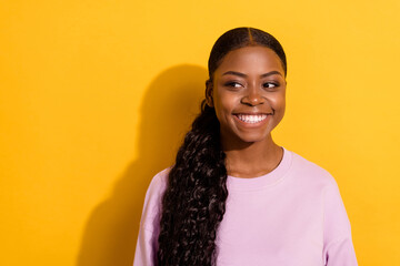 Photo of cheerful adorable lady toothy smile look interested empty space isolated on yellow color background