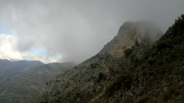 4k Shot of fog, clouds and bad weather around a mountain in Spain.