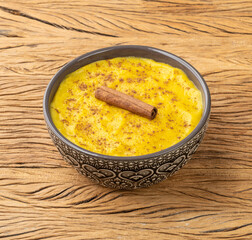 Curau, typical sweet brazilian june festival food made with corn over wooden table