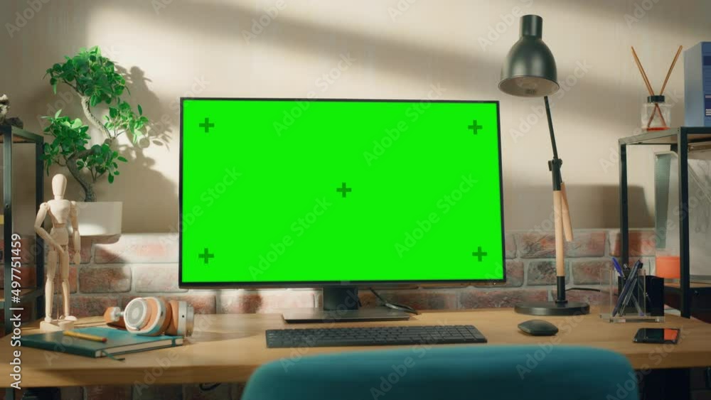 Poster desktop computer monitor standing on a table with a green screen chromakey mock up display. cozy emp