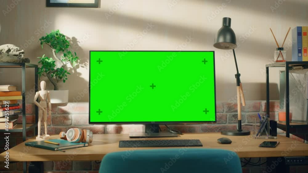 Poster desktop computer monitor standing on a desk with a green screen chromakey mock up display. cozy empt