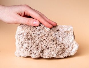 Woman hand touching stone. Sensation from stroking tough material. Thigmesthesia, taction. World...