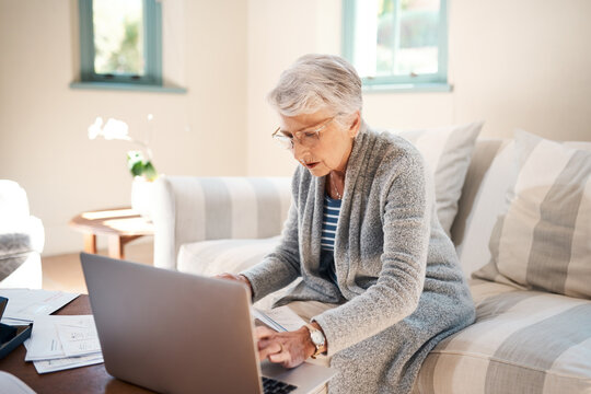 Its Never Too Late To Save. Shot Of A Senior Woman Going Through Paperwork At Home.