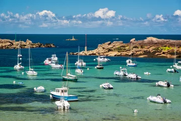 Poster Scenic landscape with boats and transparent water on Coz-Pors beach in Tregastel, Côtes d'Armor, Brittany, France © Delphotostock