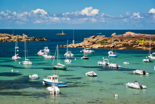 Scenic landscape with boats and transparent water on Coz-Pors beach in Tregastel, C&ocirc;tes d'Armor, Brittany, France