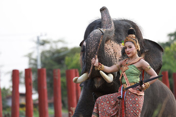 2022 Songkran goddness legendary faith name Kirini Thewi  holding weapons, gun nuts beside with elephant  , Thailand new year day call Songkran festival