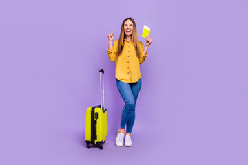 Full body photo of attractive girl raise fists in success triumph finally go on vacation isolated on purple color background