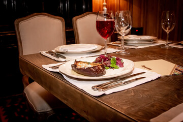 Stuffed baked eggplant lies on a plate in a restaurant