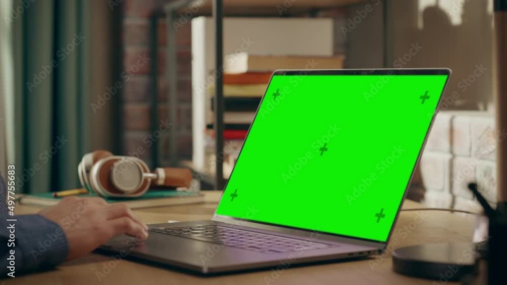 Aufkleber close up on male hands working from home on laptop computer with green screen display, person using 