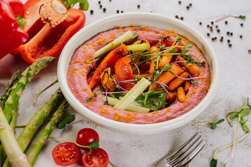 Dietary dish with boiled carrots, bell peppers and pink puree