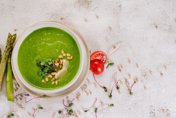 Dish of spinach cream soup and greens. Close up