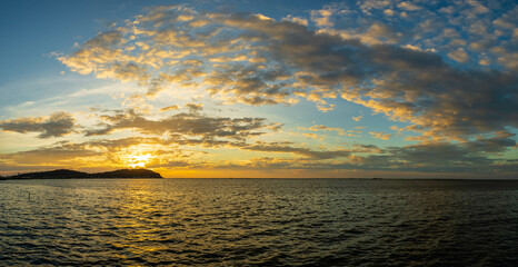atmosphere of sunset over the sea, the clouds, and the light of the sun breathtaking.