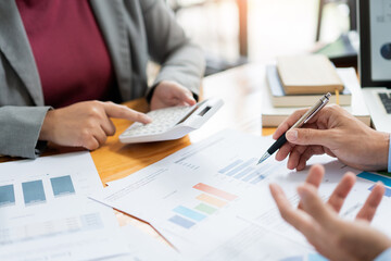 Business negotiation concept the female broker estimating the number of estate and checking it with the male broker