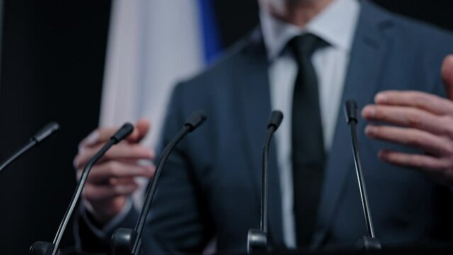 French politician delivering speech, summit speaker, giving press conference