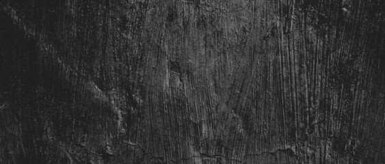Wall full of scratches. Grungy cement texture for background, Scary dark wall.Black wall