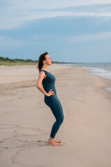 
Woman in a blue sports jumpsuit does gymnastics on the seashore
- 497759804